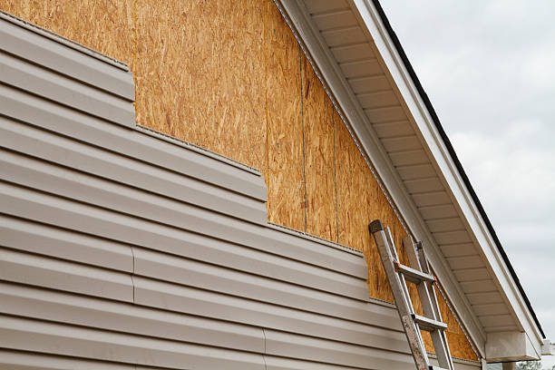 Professional Storm Damage Siding Repair technician working in Coburn, PA